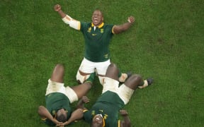 South Africa's hooker Bongi Mbonambi (C) celebrates with teammates South Africa's prop Ox Nche (L) and South Africa's prop Trevor Nyakane (R) after victory in the France 2023 Rugby World Cup Final between New Zealand and South Africa at the Stade de France in Saint-Denis, on the outskirts of Paris, on October 28, 2023. (Photo by Antonin THUILLIER / AFP)