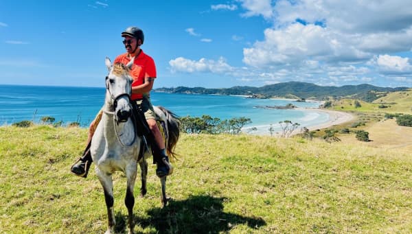The campground manager at Mimiwhangata, Manaia Armstrong, makes his rounds on horseback.