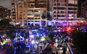 People gather at the site of a strike, reported by Lebanese media to be an Israeli strike targeting a Hamas office, in the southern suburb of Beirut on January 2, 2024. Hamas deputy leader Aruri was killed in an Israeli strike on Beirut's southern suburbs, on January 2, 2024, two security officials told AFP, with state media reporting the strike hit a Hamas office. (Photo by AFP)