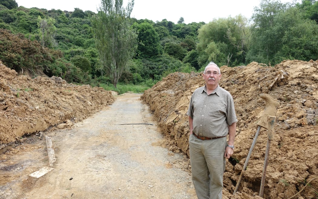 Gordon Sasse still has piles of mud, some about two metres high, surrounding his property.