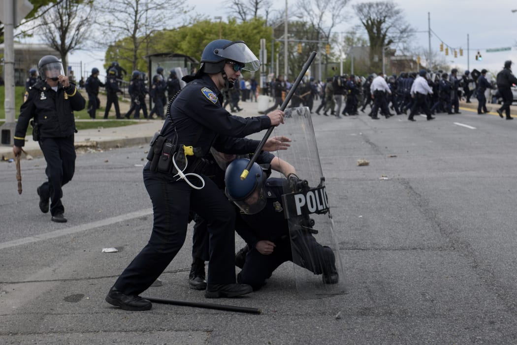 Police officers clash with protesters