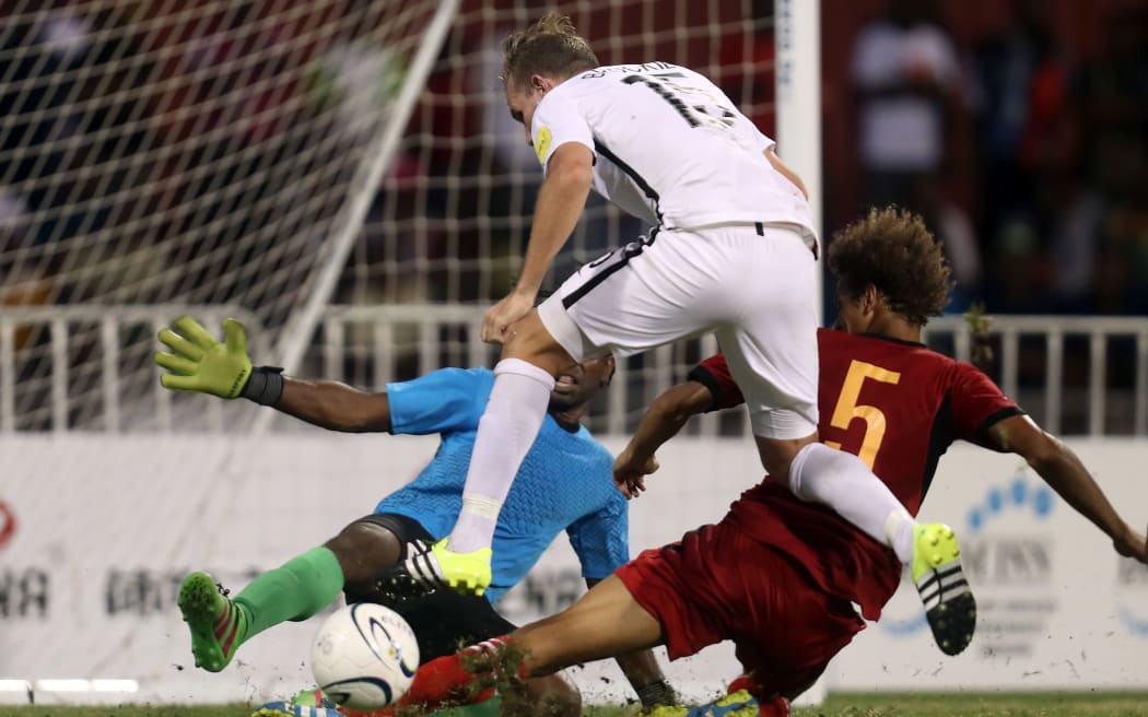 New Zealand's Jeremy Brockie is stopped by Papua New Guinea's Felix Komolong during the OFC Nations Cup in June.