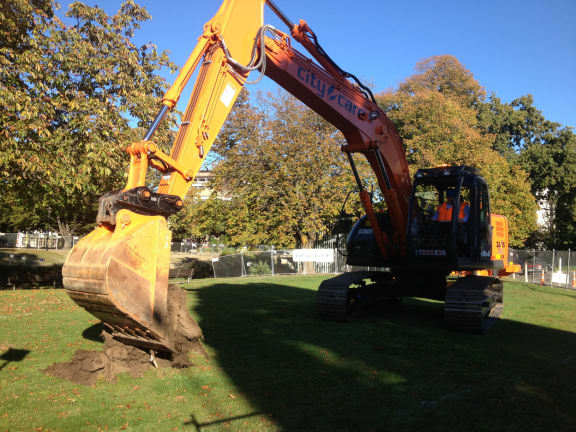 Gerry Brownlee using a digger to turn the first sod for the Avon River precinct.