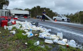 A dairy delivery truck rolled north of Kaitāia, scattering a large quantity of milk, cream and cheese across the road.