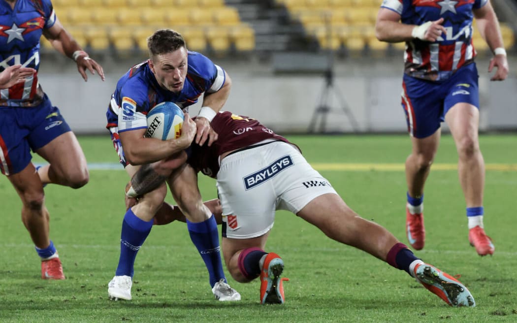 Brett Cameron, left, is tackled by Thomas Umaga-Jensen during the Hurricanes v Highlanders, Super Rugby Pacific match, Sky Stadium, Wellington.