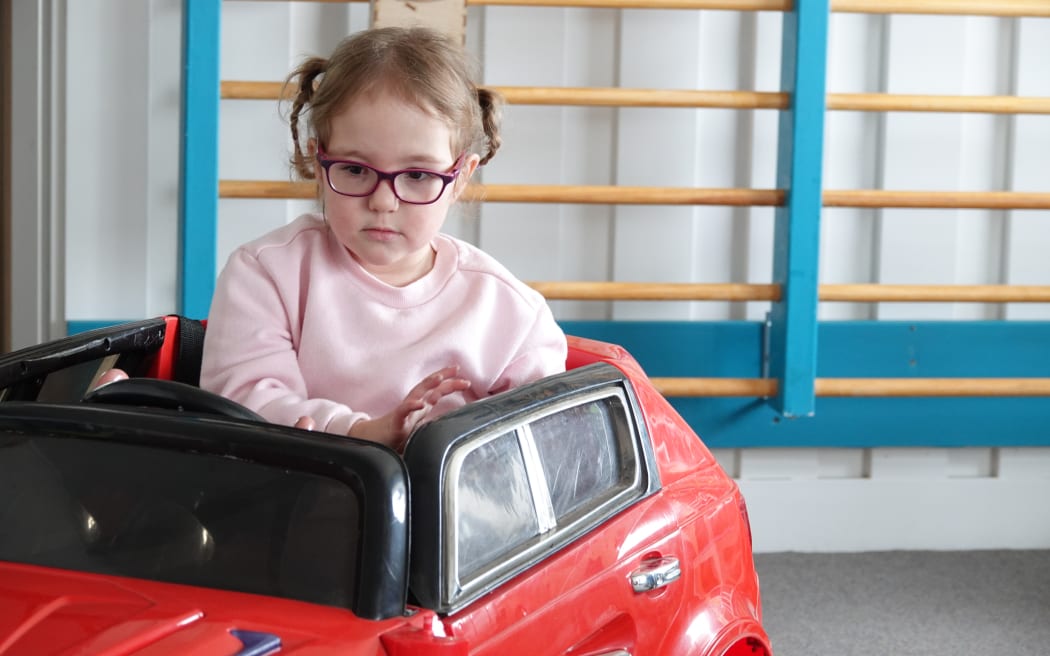Julia Tiffen tries out one of the cars donated by Kiwi Kids.