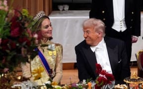 US President Donald Trump smiles at Britain's Catherine, Princess of Wales during a State Banquet at Windsor Castle, in Windsor, on September 17, 2025, during the US President's second State Visit. US President Donald Trump arrived in Britain for an unprecedented second State Visit, with the UK government rolling out a royal red carpet welcome to win over the mercurial leader. (Photo by Yui Mok / POOL / AFP)
