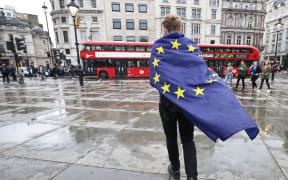 A demonstrator wrapped in a European flag leaves an anti-Brexit protest in Trafalgar Square in central London, 28 June 20016.