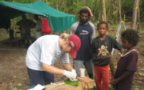 Professor Lisa Matisoo-Smith dissecting a rat on Emirau Island, Papua New Guinea.