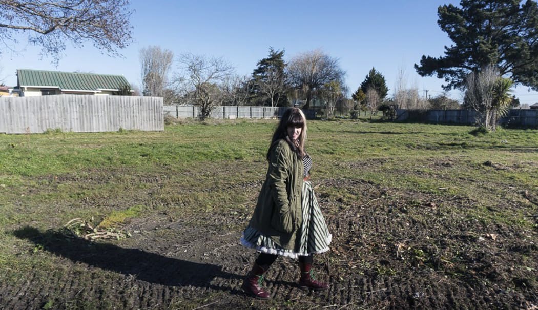 Louise Sutherland stands on the land where her house once was.