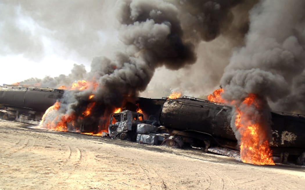 Road tankers burn in an earlier Taliban attack.