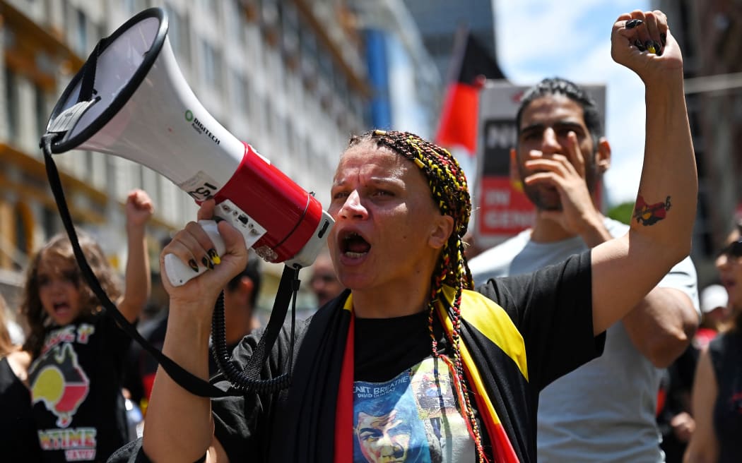Protesters take part in an "Invasion Day" demonstration on Australia Day in Sydney on January 26, 2022. (Photo by Steven Saphore / AFP) (Photo by STEVEN SAPHORE/AFP via Getty Images)