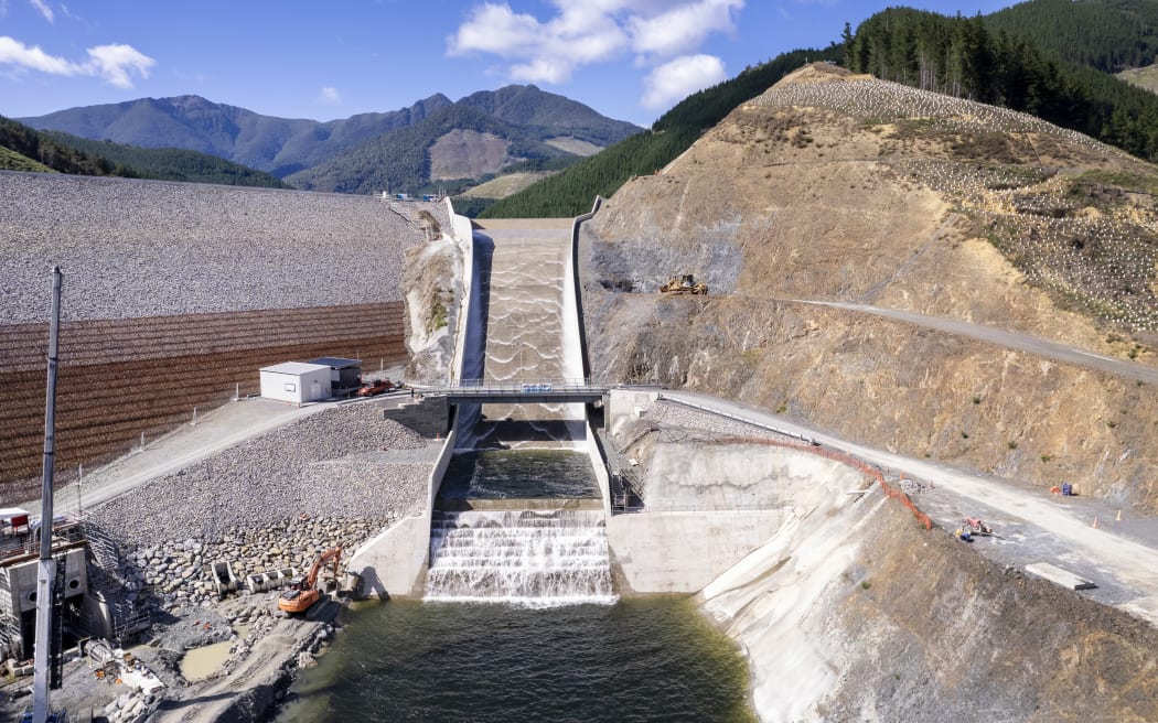 Water flows down the spillway and beneath the Nick Patterson bridge.