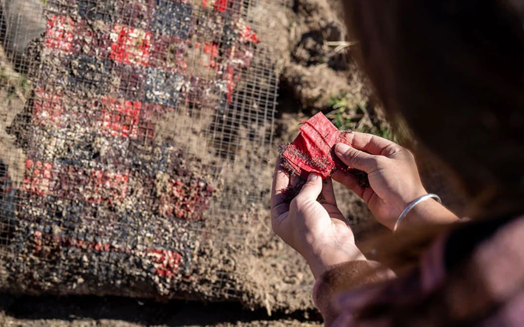The Swanndri bush shirt was split into pieces, then sandwiched between mesh and buried. The synthetic patch survived the burial.