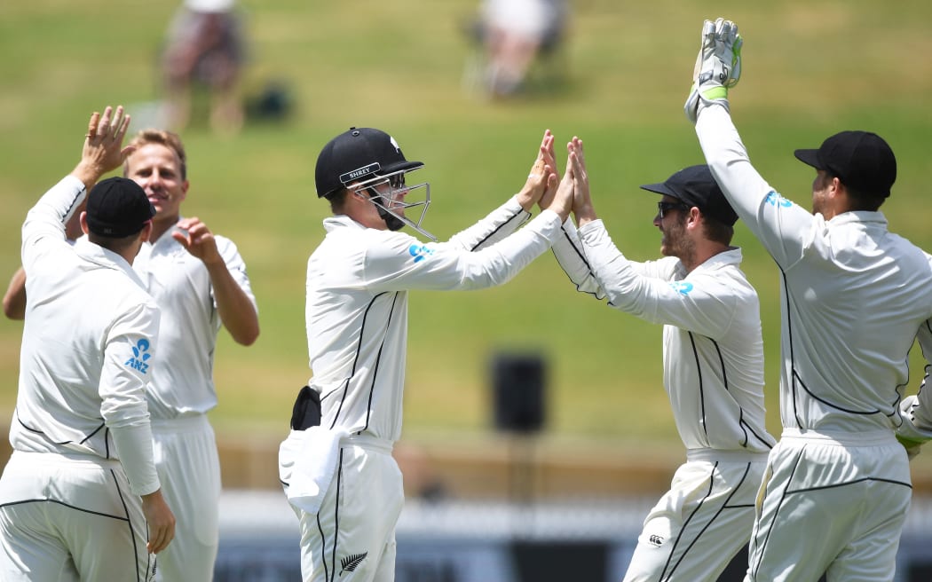 The Black Caps celebrate the fall of another West Indies wicket.
