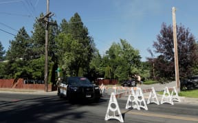 Kootenai County Sheriff’s deputies block a road leading to an area where multiple firefighters were attacked.