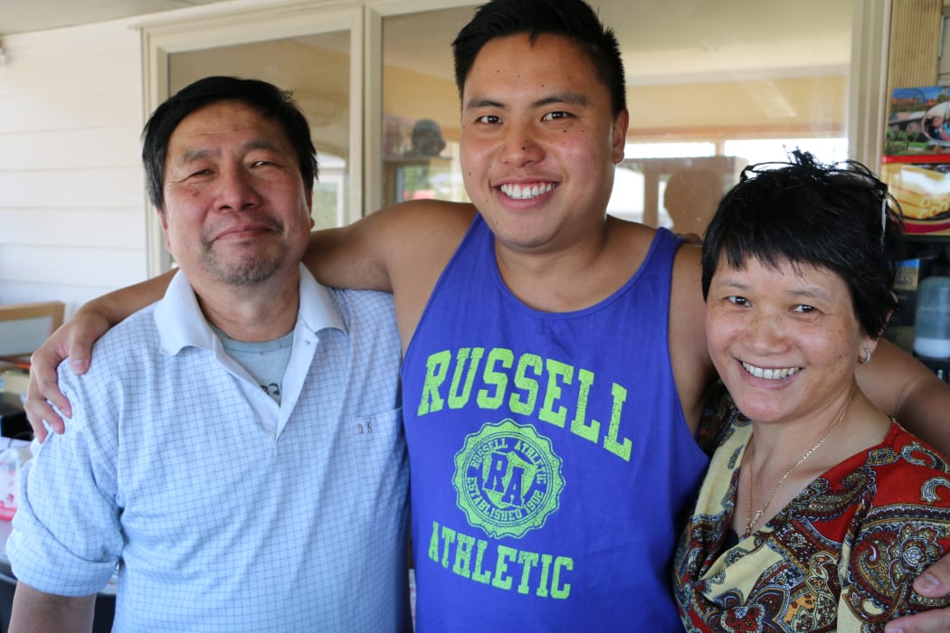 Isaiah Tour and his parents Huat and Amanda.
