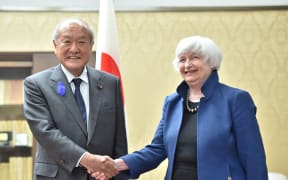 Japanese Finance Minister Shunichi Suzuki shakes hand with US Treasury Secretary Janet Yellen at the latter' office in Tokyo.