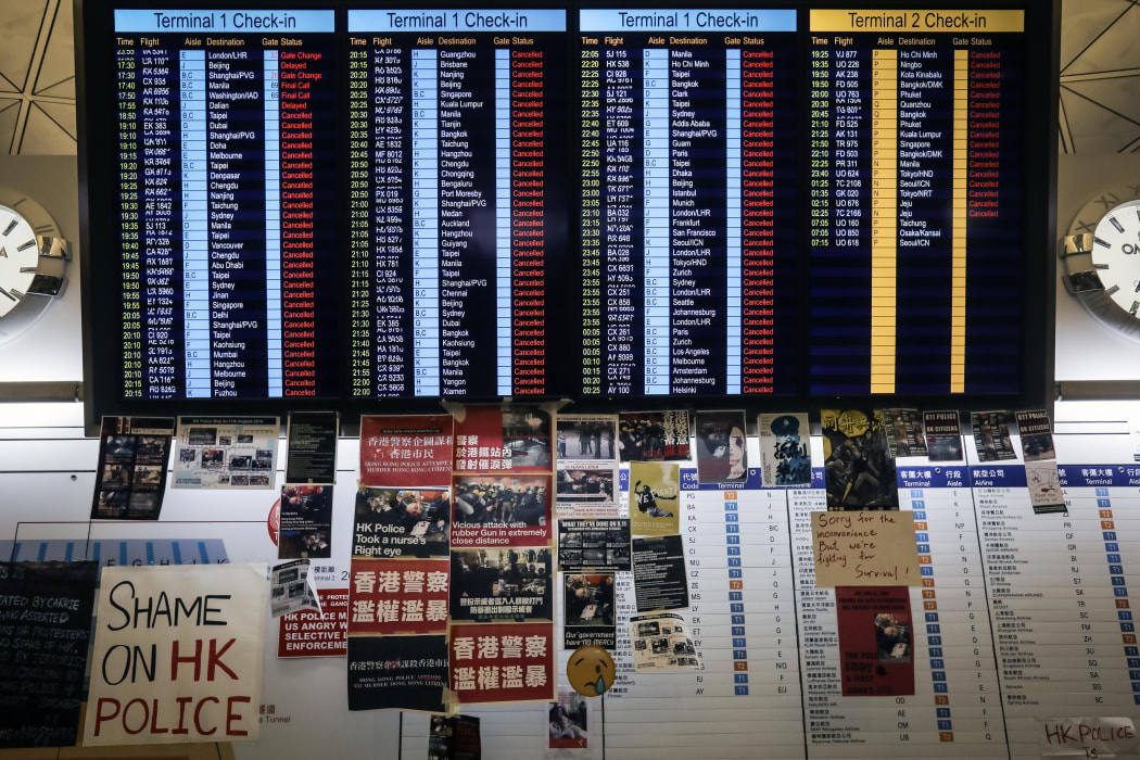 A flight information board shows cancelled flights at Hong Kong's international airport