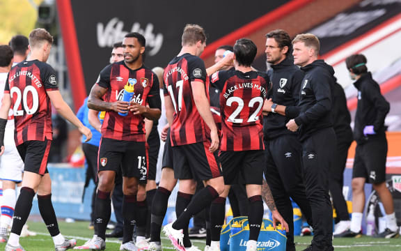Bournemouth manager Eddie Howe talks to his players.