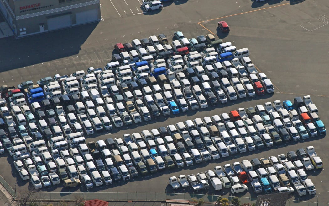 An aerial picture shows mini-vehicles lined at the logistics center adjacent to DAIHATSU MOTOR CO., LTD. headquarters in Itami, Hyogo Prefecture on Dec. 26, 2023. Daihatsu has gradually suspended operations at all four automobile factories in Japan starting from Dec. 25th due to the issue of fraudulent acquisition of national certification. Daihatsu has announced that it will continue to suspend operations at least through January, and the impact on the local economy, including its business partners, is unavoidable.( The Yomiuri Shimbun ) (Photo by Naoki Otsuka / Yomiuri / The Yomiuri Shimbun via AFP)