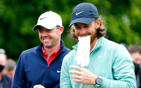 Rory McIlroy (L) and Tommy Fleetwood share a joke.