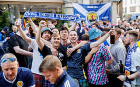 Scottish fans celebrate their team on Marienplatz in Munich ahead of Euro 2024.