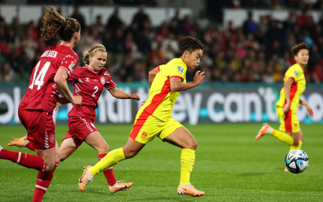 China's forward Wang Shuang eking out some space against Danish players at Perth Rectangular Stadium in Perth on 22 July, 2023.