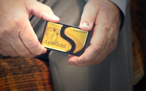 A super gold card held in someone's hands.