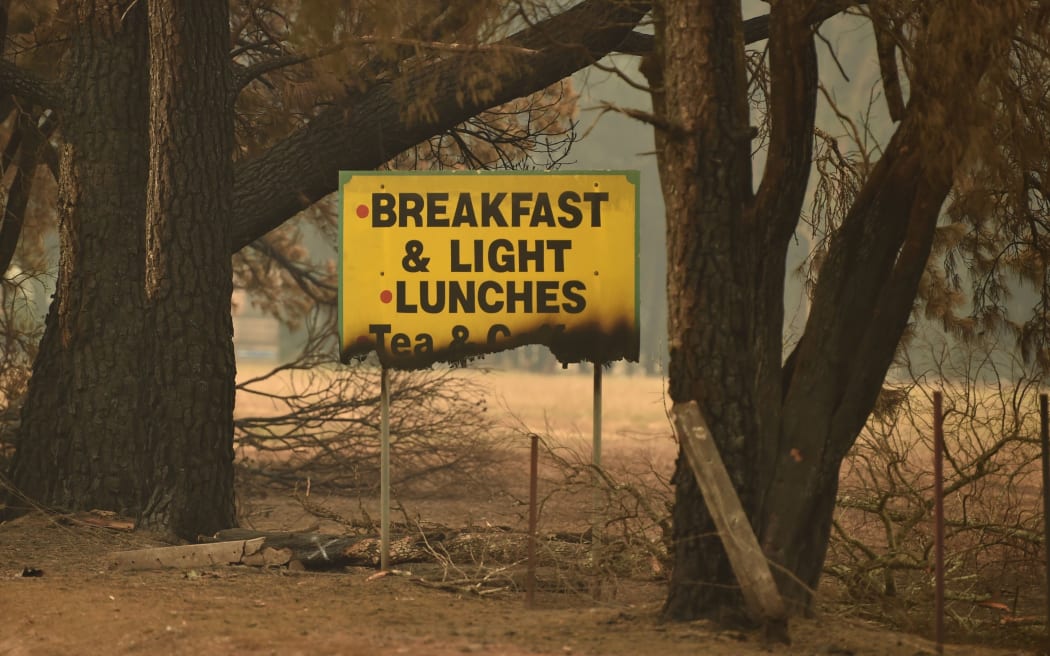 A sign if left half burnt after bushfires ravaged the town of Bilpin, 70km west of Sydney on December 29, 2019.