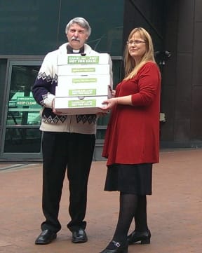Mark Beale hands the petition to Green MP Denise Roche.