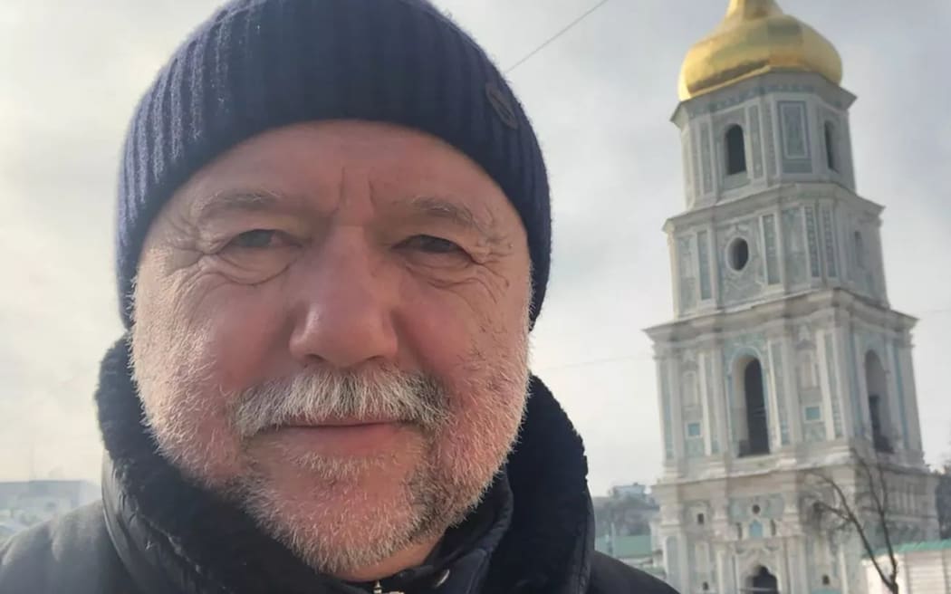 Ukrainian writer Andrey Kurkov in front of a church
