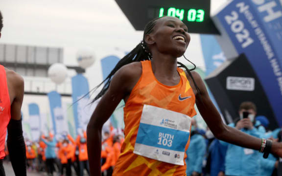 Kenyan runner Ruth Chepngetich celebrates after she smashed the women's half marathon world record with clocking a time of 1:04:02, in Istanbul, Turkey on April 04, 2021.