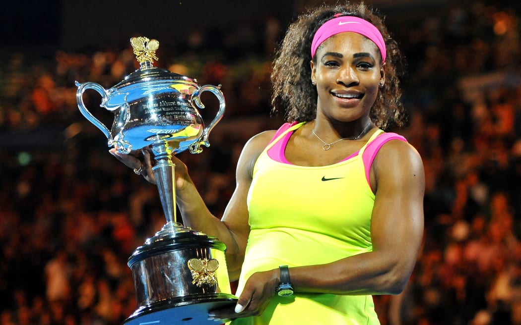 Serena Williams poses with the Australian Open trophy for the sixth time