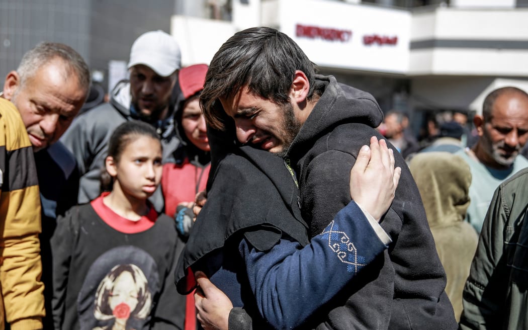 EDITORS NOTE: Graphic content / People mourn following an early morning incident when residents rushed toward aid trucks in Gaza City on February 29, 2024.. The health ministry in Hamas-run Gaza said Israeli forces shot dead dozens of people when a crowd rushed towards aid trucks on February 29. Israeli sources confirmed that troops opened fire at Palestinians, with one saying soldiers thought they "posed a threat", and that many died when they were run over by aid trucks. (Photo by AFP) / “The erroneous mention[s] appearing in the metadata of this photo by - has been modified in AFP systems in the following manner: [caption content] . Please immediately remove the erroneous mention[s] from all your online services and delete it (them) from your servers. If you have been authorized by AFP to distribute it (them) to third parties, please ensure that the same actions are carried out by them. Failure to promptly comply with these instructions will entail liability on your part for any continued or post...