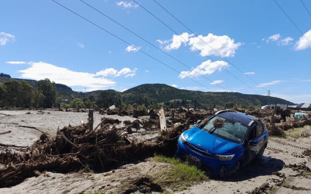 Damaged vehicles, broken powerlines and piles of silt line State Highway 5 in Esk Valley, after Cyclone Gabrielle.