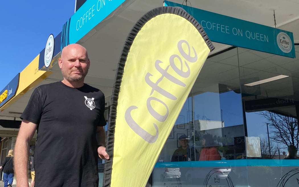 Coffee on Queen owner Matt Redwood says not displaying his flag would cost him up to $300 in lost sales each day.