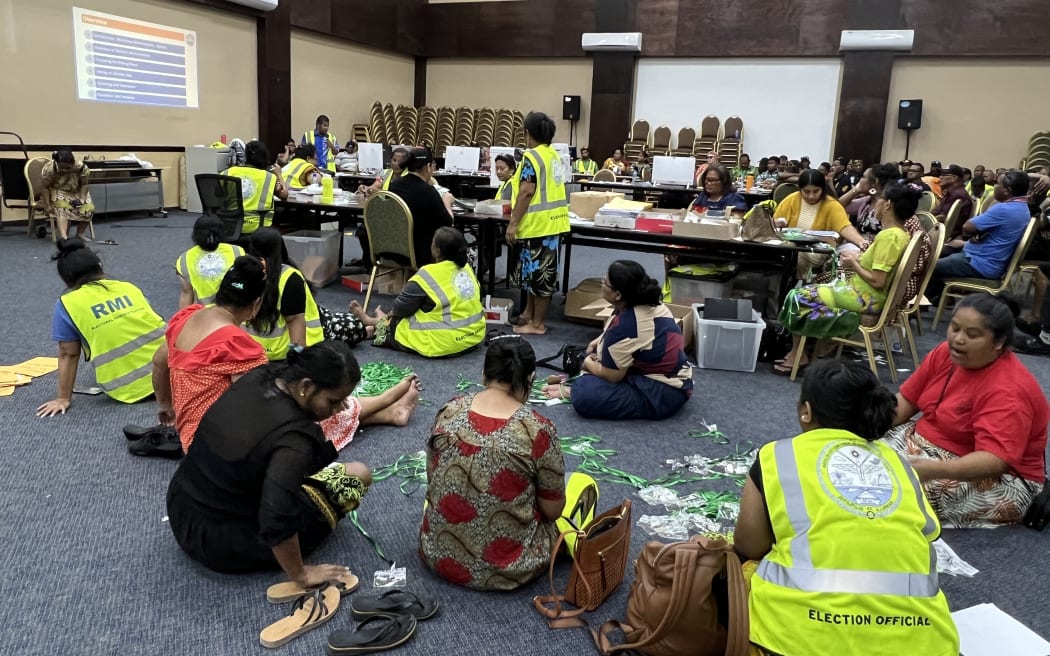The government's International Conference Center has been turned into election headquarters, with dozens of election staff preparing ballots, voter rolls, ID badges and other supplies for the 20 November national election.