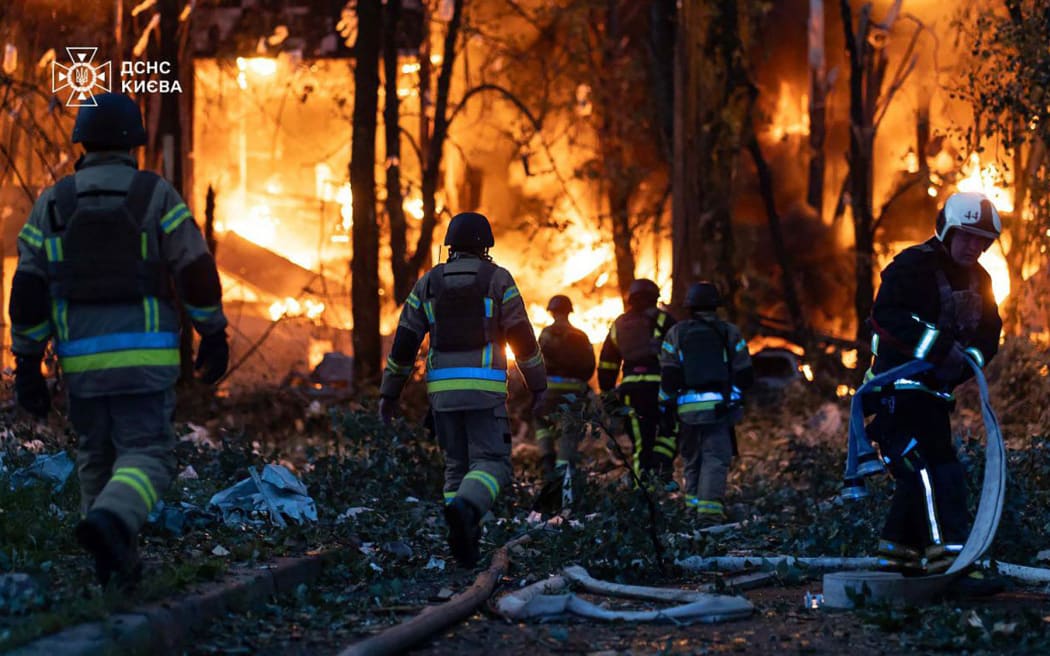 This handout photograph taken and released by the State Emergency Service of Ukraine on July 4, 2025, shows firefighters working on a fire at a site of a strike following a mass Russian drone and missile attack on the Ukraine's capital Kyiv, amid the Russian invasion of Ukraine. Russia launched its largest-ever drone and missile attack on Ukraine overnight on July 4 just hours after a telephone call between US and Russian presidents ended without any breakthrough. (Photo by Handout / State Emergency Service of Ukraine / AFP) / RESTRICTED TO EDITORIAL USE - MANDATORY CREDIT "AFP PHOTO / STATE EMERGENCY SERVICE OF UKRAINE / HANDOUT" - NO MARKETING NO ADVERTISING CAMPAIGNS - DISTRIBUTED AS A SERVICE TO CLIENTS