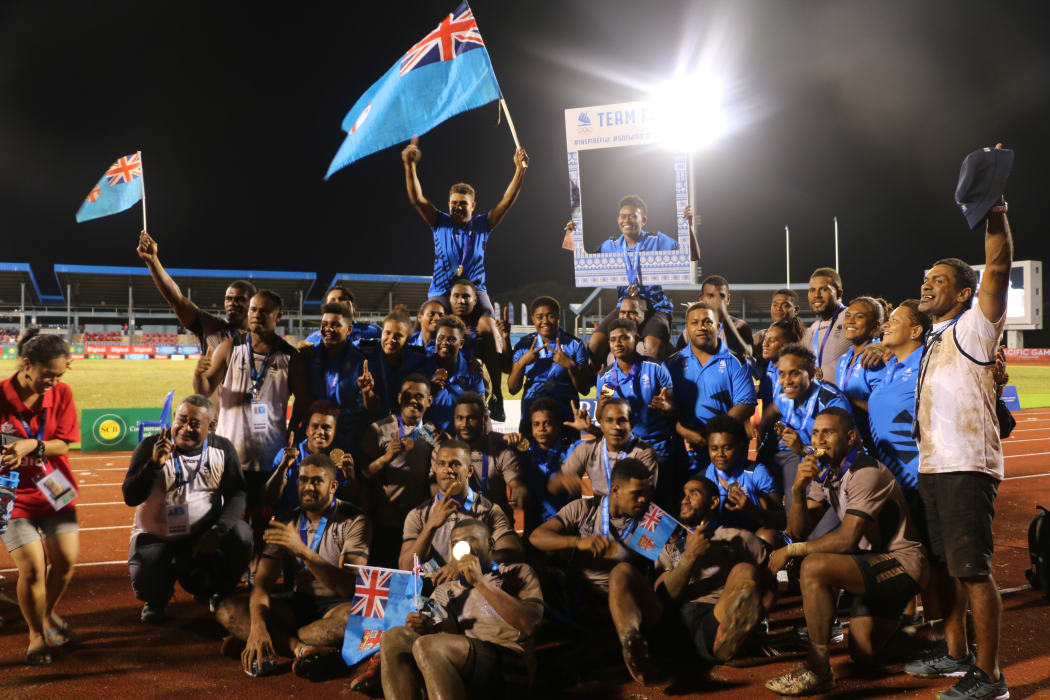 Fiji league teams celebrating their gold medals.