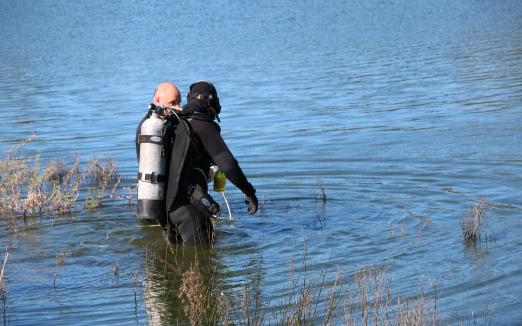 Divers going into the lake at Westlake Reserve, 13 September 2017.