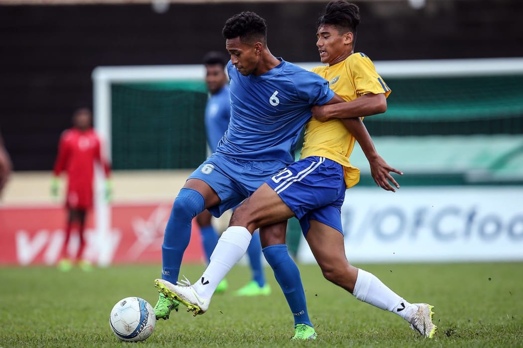 Fiji's Mohammed Naizal receives some close attention from Solomon Island's Marcus Chan