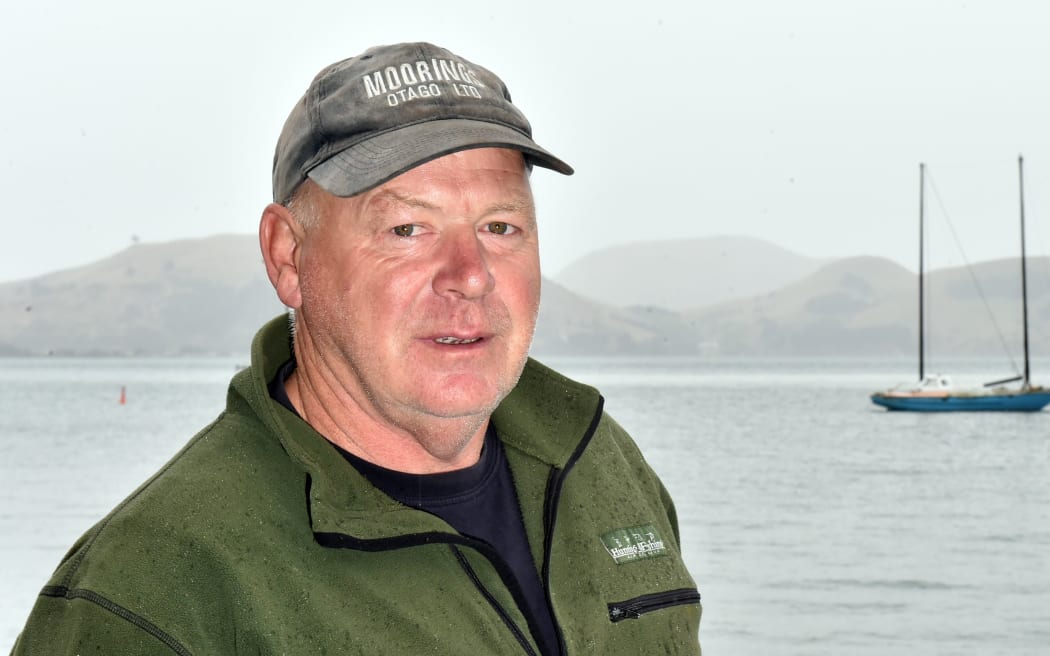 Moorings Otago Ltd owner, Kevin Waters, looks out at the abandoned yacht.