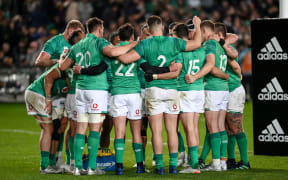 A dejected Ireland team huddle.