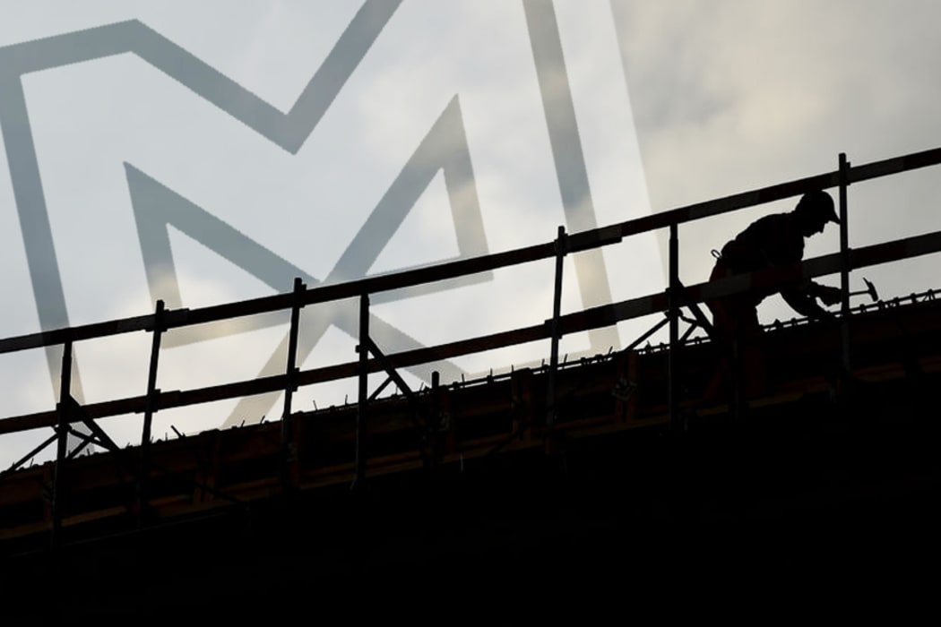 construction worker silhouette on a construction with coudy sky on background