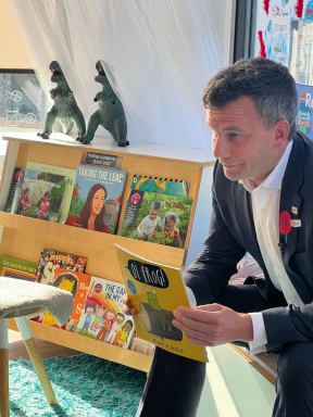 ACT leader David Seymour reads to children, next to 'Taking The Lead', a book about former prime minister Jacinda Ardern.