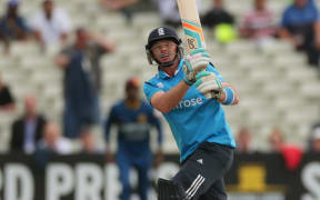 England cricket batsman Ian Bell hits a shot high into the air.