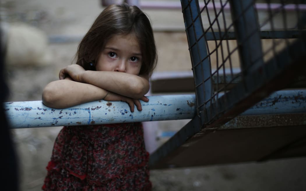 A Syrian girl looks on in the city of Hamouria in Damascus province on the third day of Eid al-Adha celebrations on September 26, 2015.