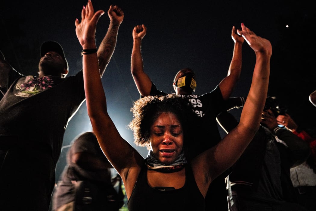 Demonstrators gather for staging a protest after an Atlanta police officer shot and killed Rayshard Brooks, 27, at a Wendy's fast food restaurant drive-thru Friday night in Atlanta, United States on June 14, 2020.