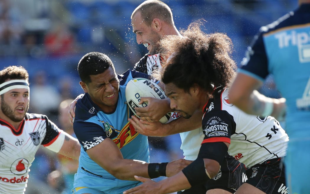 Moeaki Fotuaika carries the ball for the Gold Coast Titans during a July game against the Warriors
